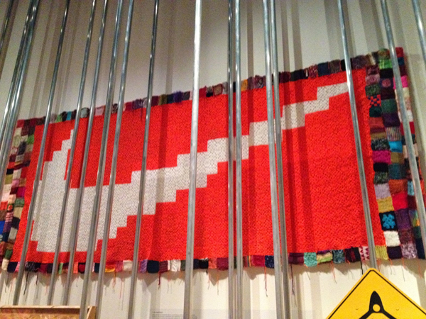 Cat Mazza and Knit Hobbyists. Nike Blanket, 2003-2008. Knitted and crocheted wool. 15 x 4.5 ft. Private Collection. Image courtesy of MicroRevolt. 