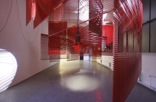 Haegue Yang. Installation Shot of Mountains of Encounter. 2008. Aluminum Venetian blinds, powder-coated aluminum hanging structure, steel wire, moving spotlights, floodlights, platform ladder, and cable. Dimensions Variable. Image courtesy of Fred Dott, Hamburg, Germany.